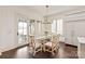 Bright dining room with glass table, chandelier, and access to the outdoor patio at 314 Royal Crescent Ln, Waxhaw, NC 28173