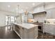 Chef's kitchen with gas range, custom vent hood, and sleek countertops at 314 Royal Crescent Ln, Waxhaw, NC 28173