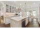 Bright, modern kitchen with a large center island, stainless steel appliances, and white cabinets at 314 Royal Crescent Ln, Waxhaw, NC 28173