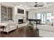 Elegant living room featuring coffered ceilings, a fireplace, and large windows at 314 Royal Crescent Ln, Waxhaw, NC 28173