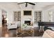 Bright living room featuring a fireplace, built-in bookshelves, and grand piano at 314 Royal Crescent Ln, Waxhaw, NC 28173
