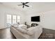 Living room with white vaulted ceiling, dark wood floors, and access to an outdoor seating area at 314 Royal Crescent Ln, Waxhaw, NC 28173