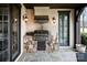 Close-up of an outdoor kitchen with a stainless steel grill, stone detailing, and dark wood accents at 314 Royal Crescent Ln, Waxhaw, NC 28173