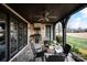 Outdoor kitchen with built-in grill, stone surround, and dark wood ceiling on covered patio at 314 Royal Crescent Ln, Waxhaw, NC 28173