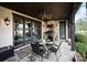 Covered patio featuring an outdoor kitchen, ceiling fan, dining table, and multiple glass doors leading inside at 314 Royal Crescent Ln, Waxhaw, NC 28173