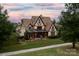 Expansive rear of home features covered porch overlooking the beautifully landscaped yard at 314 Royal Crescent Ln, Waxhaw, NC 28173