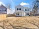 The back of the home showcases a fenced backyard, air conditioning unit, and space at 3215 Isenhour St, Charlotte, NC 28206