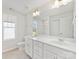 An elegant bathroom features double sinks, a large mirror, and tiled floors at 3215 Isenhour St, Charlotte, NC 28206