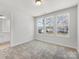Bright bedroom with three windows and a doorway leading to an attached bathroom at 3215 Isenhour St, Charlotte, NC 28206