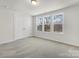 An airy bedroom features carpeted floors and large windows for natural light at 3215 Isenhour St, Charlotte, NC 28206