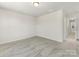 An airy bedroom features carpeted floors and an entrance to the bathroom at 3215 Isenhour St, Charlotte, NC 28206