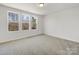 An airy bedroom features carpeted floors and large windows for natural light at 3215 Isenhour St, Charlotte, NC 28206