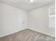 An airy bedroom features carpeted floors and a large window at 3215 Isenhour St, Charlotte, NC 28206