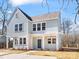 Charming two-story home featuring light blue siding, white trim, a welcoming porch, and a well-maintained front yard at 3215 Isenhour St, Charlotte, NC 28206