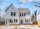 Charming two-story home featuring light blue siding, white trim, a welcoming porch, and a well-maintained front yard at 3215 Isenhour St, Charlotte, NC 28206