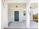 Close-up of front porch featuring stylish lighting, white columns, a modern dark blue door, and the house number at 3215 Isenhour St, Charlotte, NC 28206