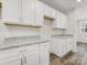 Bright kitchen features white cabinets and granite countertops at 3215 Isenhour St, Charlotte, NC 28206