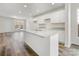 Modern kitchen featuring white cabinets, granite countertops, stainless steel sink, and wood-look floors at 3215 Isenhour St, Charlotte, NC 28206