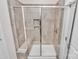 Bright bathroom showcases a glass-enclosed shower with grey tile surround and built-in bench at 3532 Tully Ave, Kannapolis, NC 28081
