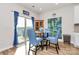 Cozy dining area with a round table, blue chairs, artwork, and a sliding glass door at 3532 Tully Ave, Kannapolis, NC 28081