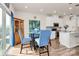 Dining area with a round table, blue chairs, artwork, and access to the kitchen at 3532 Tully Ave, Kannapolis, NC 28081