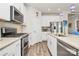 Well-equipped kitchen showcasing stainless steel appliances, white cabinets, and stone countertops at 3532 Tully Ave, Kannapolis, NC 28081