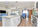 Kitchen island with a sink and breakfast bar with an adjacent dining area and living room at 3532 Tully Ave, Kannapolis, NC 28081