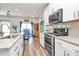 Bright kitchen featuring stainless steel appliances, a kitchen island with a sink, and a dining area at 3532 Tully Ave, Kannapolis, NC 28081