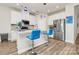 Contemporary kitchen featuring white cabinets, granite countertops, stainless steel appliances, and blue barstools at 3532 Tully Ave, Kannapolis, NC 28081