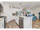 Open concept kitchen with white cabinetry, stainless steel appliances, a center island, and hardwood floors at 3532 Tully Ave, Kannapolis, NC 28081