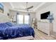 A bright primary bedroom with a tray ceiling, ceiling fan and blue accents create a relaxing atmosphere at 3532 Tully Ave, Kannapolis, NC 28081