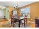 Charming dining room features a patterned rug, window views, classic chandelier, and wooden dining set at 3701 Fieldhaven Ct, Maiden, NC 28650