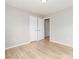 This bright bedroom features neutral walls, laminate flooring, and two doors for easy access at 417 Columbus Ln, Monroe, NC 28110