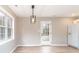 Dining space with modern lighting, door to the backyard and view to the kitchen and stainless steel refrigerator at 417 Columbus Ln, Monroe, NC 28110