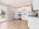 Bright kitchen featuring white cabinets, stainless steel appliances, and wood-look flooring at 417 Columbus Ln, Monroe, NC 28110