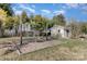 Spacious backyard featuring a swing set, an outbuilding, and mature trees, offering a perfect blend of recreation and relaxation at 4321 Rolling Acres Rd, Charlotte, NC 28213