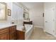 Bright and spacious bathroom with dual vanities, a soaking tub, and a large window for natural light at 4321 Rolling Acres Rd, Charlotte, NC 28213