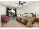 Spacious bedroom featuring a large window, soft carpet, cozy chair, and an inviting atmosphere at 4321 Rolling Acres Rd, Charlotte, NC 28213
