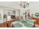 Formal dining room with wood floors, chandelier, and access to the kitchen and other living spaces at 4321 Rolling Acres Rd, Charlotte, NC 28213