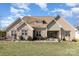 Charming brick home featuring a well-manicured lawn, inviting front porch, and an array of decorative shrubbery at 4321 Rolling Acres Rd, Charlotte, NC 28213