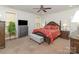 Inviting main bedroom with a decorative ceiling fan, soft carpet, and an abundance of natural light at 4321 Rolling Acres Rd, Charlotte, NC 28213