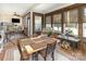 Inviting sunroom with many windows, wood walls, and a wood table and chairs at 4321 Rolling Acres Rd, Charlotte, NC 28213