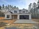 Charming two-story home with light beige siding, black roof, and an open two-car garage nestled in a wooded lot at 44401 Us 52 N Hwy, Richfield, NC 28137