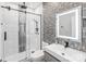 Modern bathroom with glass shower, mosaic accent wall, updated vanity, and a large illuminated mirror at 5000 Tulip Ln, Matthews, NC 28104