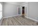 Serene bedroom featuring light gray vinyl floors, crisp white trim, and a bright white french door at 5000 Tulip Ln, Matthews, NC 28104