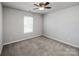 This bedroom offers carpeted floors, a ceiling fan and a large window for great natural lighting at 5000 Tulip Ln, Matthews, NC 28104