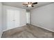 This bedroom is a blank canvas with neutral walls, carpet, closet and has entries to other rooms at 5000 Tulip Ln, Matthews, NC 28104