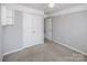 This bedroom is a blank canvas with neutral walls, carpet, closet and has entries to other rooms at 5000 Tulip Ln, Matthews, NC 28104