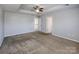 This bedroom is a blank canvas with neutral walls, carpet and has entries to other rooms at 5000 Tulip Ln, Matthews, NC 28104