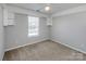 This bedroom offers carpeted floors, a ceiling fan and a large window for natural lighting at 5000 Tulip Ln, Matthews, NC 28104